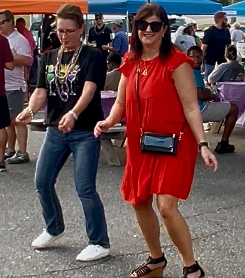 Two women dancing at the Mardi Gras event