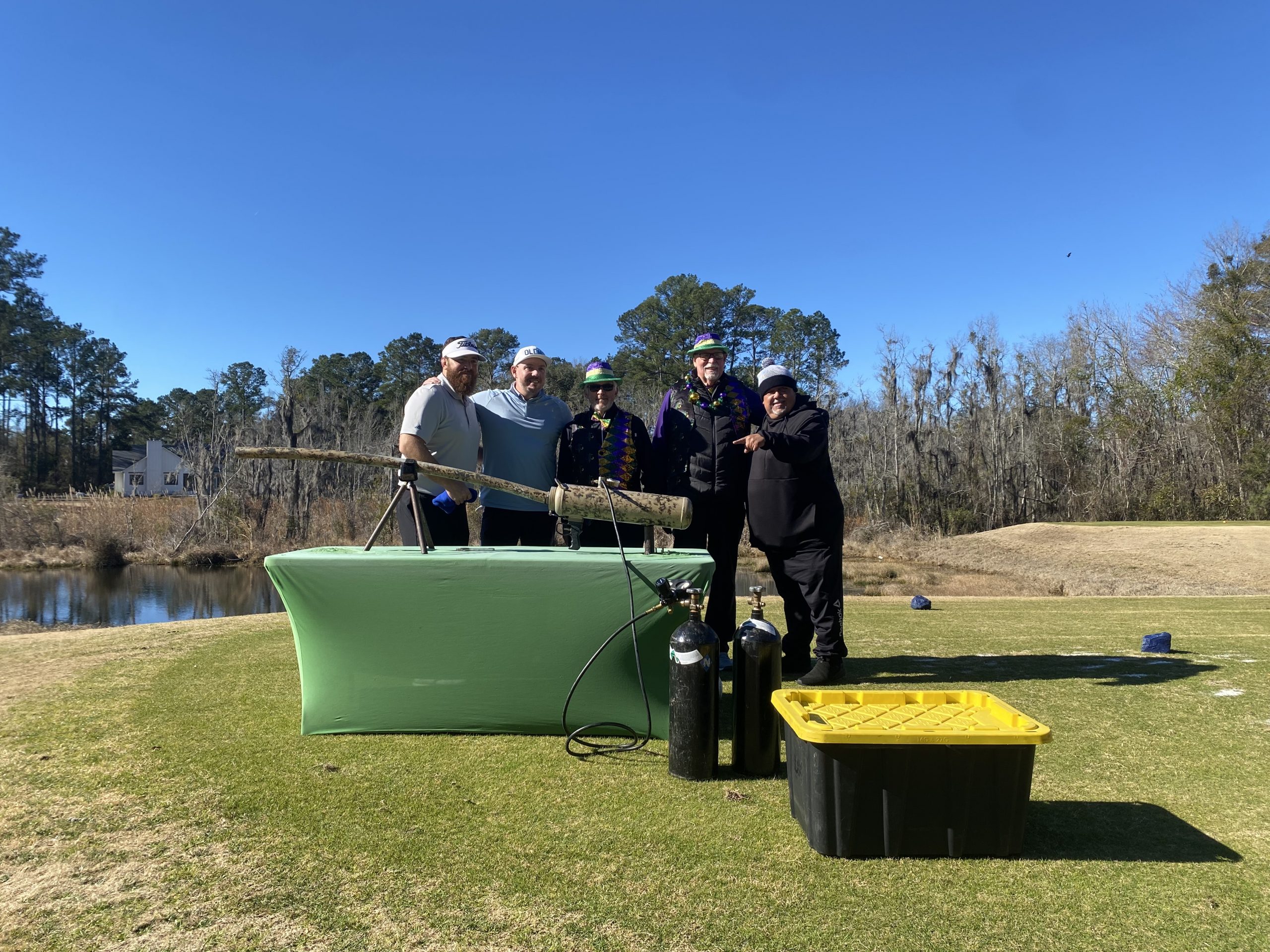 Five men at a Mardi Gras contraption on a table